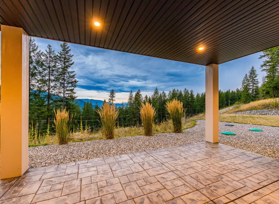 Enjoy breathtaking mountain views from this covered patio, perfect for outdoor entertaining or quiet relaxation.