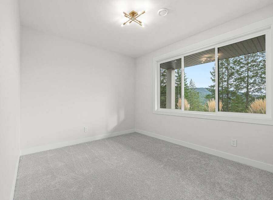 Experience breathtaking natural views from this spacious room, featuring a large window that floods the space with natural light.