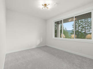 Experience breathtaking natural views from this spacious room, featuring a large window that floods the space with natural light.