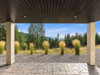 Enjoy breathtaking mountain views from this covered patio, perfect for outdoor entertaining or quiet relaxation.