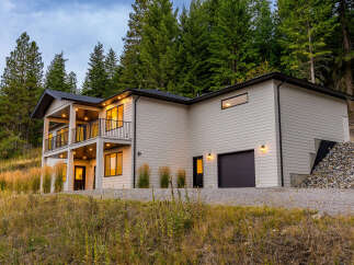 Nestled amidst a serene forest, this modern home offers stunning natural views and contemporary living.
