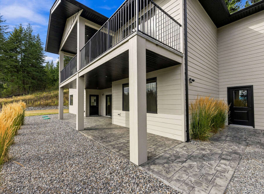 Experience modern living in this stunning home featuring a spacious covered patio perfect for outdoor entertaining.