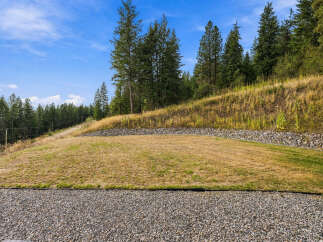 Discover the potential of this expansive lot, featuring a gently sloping lawn perfect for outdoor activities.