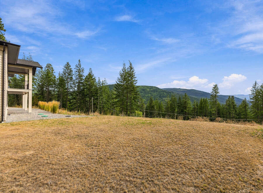 Experience breathtaking mountain views from this stunning property, featuring a modern home with expansive outdoor living spaces.