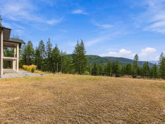 Experience breathtaking mountain views from this stunning property, featuring a modern home with expansive outdoor living spaces.