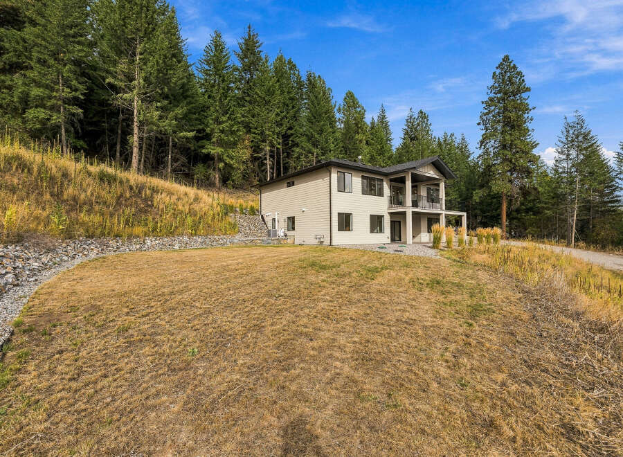 Nestled amidst a serene forest, this modern home offers a tranquil retreat with stunning natural surroundings.