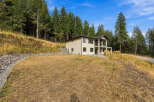 Nestled amidst a serene forest, this modern home offers a tranquil retreat with stunning natural surroundings.