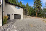 Discover this stunning property featuring a modern garage with a sleek dark door and a stylish horizontal window.