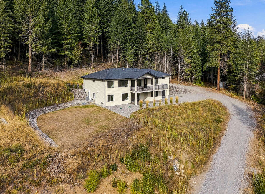 Nestled amidst a lush evergreen forest, this stunning home offers a serene retreat.