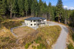 Nestled amidst a lush evergreen forest, this stunning home offers a serene retreat.