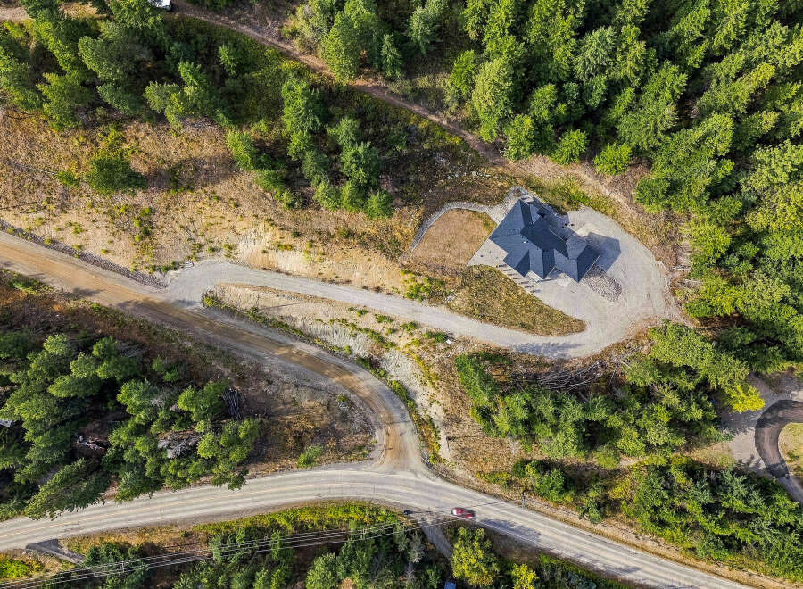 Discover this stunning property featuring a modern home nestled amidst lush greenery and mature trees.