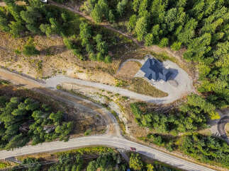 Discover this stunning property featuring a modern home nestled amidst lush greenery and mature trees.