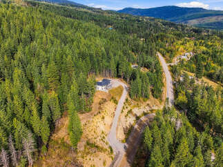 Nestled amidst a lush, evergreen forest, this stunning modern home offers unparalleled privacy and breathtaking natural beauty.