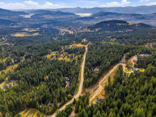 Experience luxury living nestled within a private, wooded estate offering breathtaking panoramic views of the valley and distant mountains.