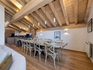 Experience luxurious alpine living in this stunning dining area, featuring a grand live-edge dining table perfect for gatherings.