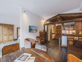 Experience rustic charm in this alpine-inspired living space, featuring exposed wooden beams and a cozy seating area.