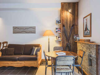 Experience rustic charm in this inviting living and dining area, featuring a cozy wooden sofa and a rustic dining set perfect for intimate meals.