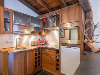 Discover this charming alpine kitchen, featuring warm wooden cabinetry and modern stainless steel appliances.