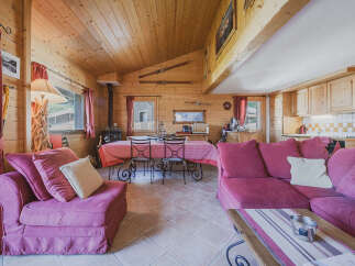 Experience cozy living in this charming wooden cabin, featuring a spacious living and dining area perfect for gatherings.