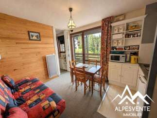 This charming apartment features a cozy living area with a comfortable sofa and a dining table perfect for intimate meals.