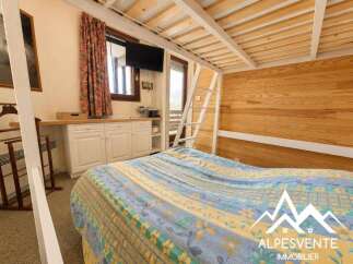 This charming room features a comfortable bed with a colorful comforter, perfect for a cozy retreat.