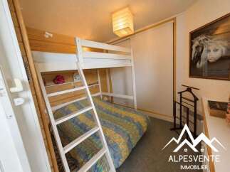 This charming bedroom features a space-saving bunk bed, perfect for families or accommodating guests.