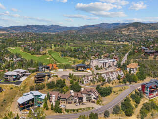 Experience luxury mountain living in this stunning estate, perfectly situated with panoramic views of rolling hills and a pristine golf course.