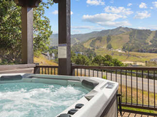 Indulge in ultimate relaxation with this luxurious hot tub, offering breathtaking mountain views and a serene escape.