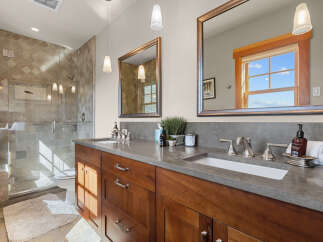 Experience luxury in this stunning bathroom featuring a spacious walk-in shower with elegant tile work and a modern glass enclosure.
