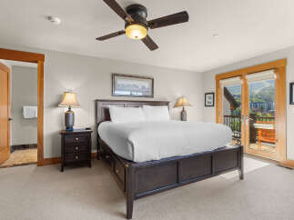Experience ultimate comfort in this spacious bedroom, featuring a luxurious king-sized bed and a private balcony with stunning mountain views.