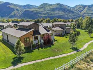 Discover modern living in this stunning home, featuring a striking architectural design with wood and stucco accents.