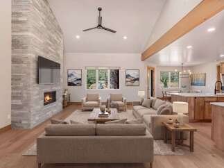 Experience luxurious mountain living in this stunning open-concept home, featuring a grand stone fireplace and vaulted ceilings.