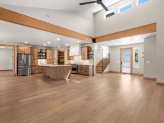 Experience modern living in this spacious open-concept home, featuring a gourmet kitchen with a large island and ample cabinetry.