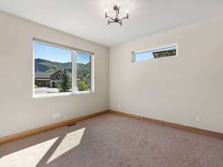 Experience breathtaking mountain views from this spacious room, featuring large windows that flood the space with natural light.