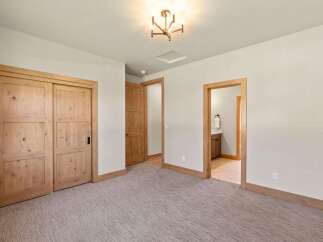 Step into this inviting bedroom featuring a spacious closet with elegant wooden sliding doors.