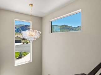 Experience breathtaking mountain views from this stunning home, framed by expansive windows.