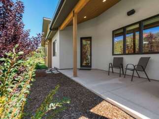 Enjoy the serene mountain views from this modern home's covered patio, perfect for relaxing evenings.