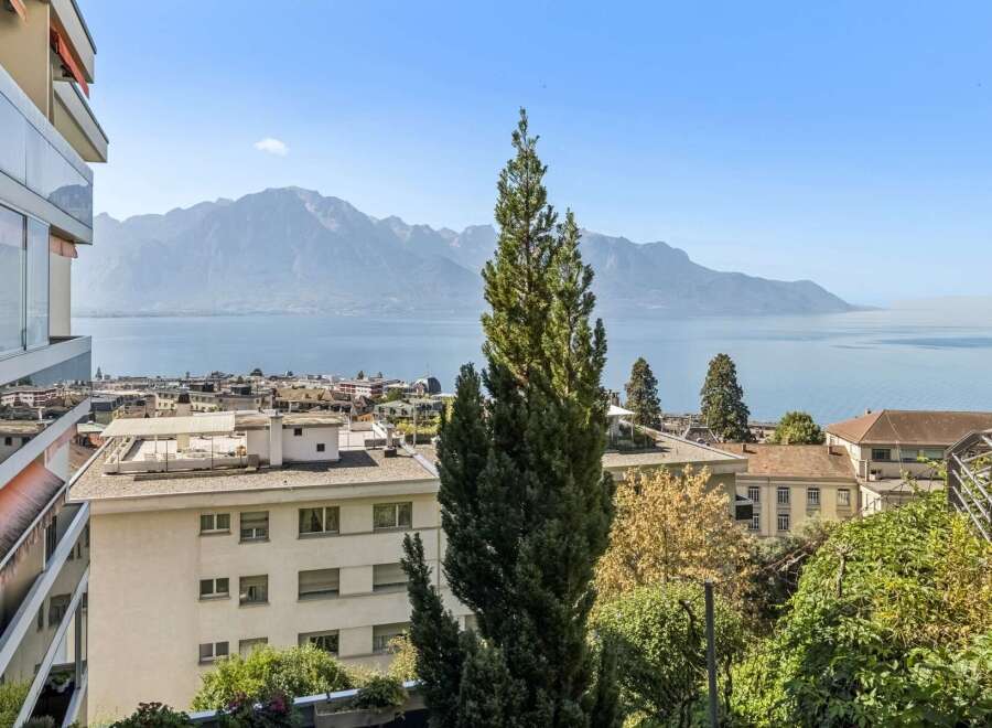 Experience breathtaking panoramic views of the serene lake and majestic mountains from this exceptional property.