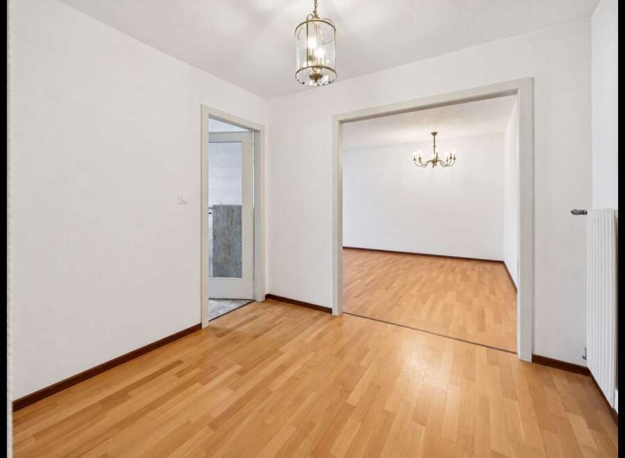Step into this inviting space featuring gleaming hardwood floors that extend throughout the home.