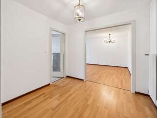 Step into this inviting space featuring gleaming hardwood floors that extend throughout the home.