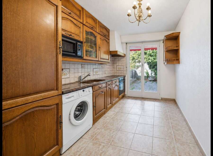 Discover this charming kitchen featuring warm wooden cabinetry and a convenient built-in microwave.
