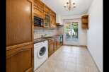 Discover this charming kitchen featuring warm wooden cabinetry and a convenient built-in microwave.