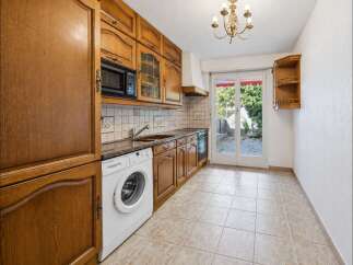 Discover this charming kitchen featuring warm wooden cabinetry and a convenient built-in microwave.