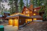 Nestled amidst towering trees, this stunning wooden A-frame home offers a luxurious mountain retreat.