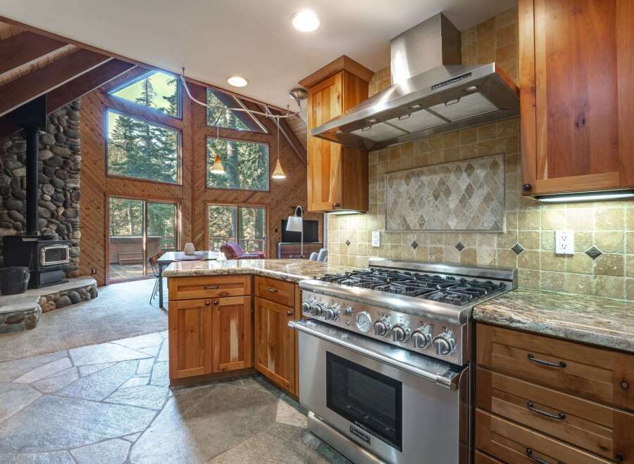 Experience rustic charm in this stunning kitchen featuring a professional-grade gas range and granite countertops.
