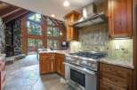 Experience rustic charm in this stunning kitchen featuring a professional-grade gas range and granite countertops.