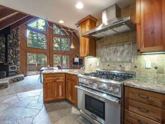 Experience rustic charm in this stunning kitchen featuring a professional-grade gas range and granite countertops.
