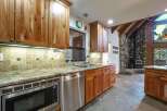 This stunning kitchen boasts custom wood cabinetry and granite countertops, perfect for a gourmet chef.