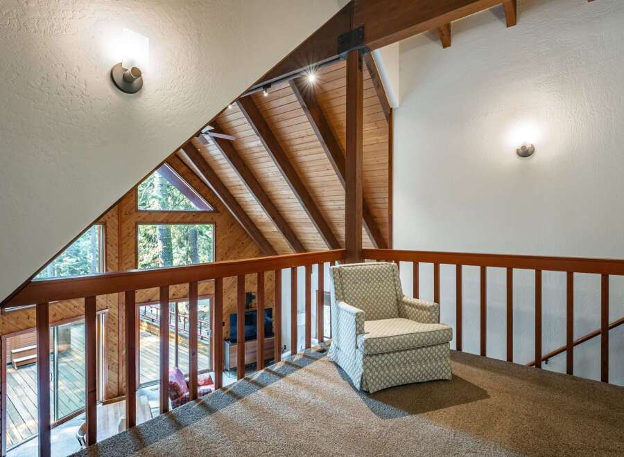 Experience the charm of this rustic loft with its stunning A-frame architecture and exposed wooden beams.