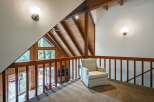 Experience the charm of this rustic loft with its stunning A-frame architecture and exposed wooden beams.